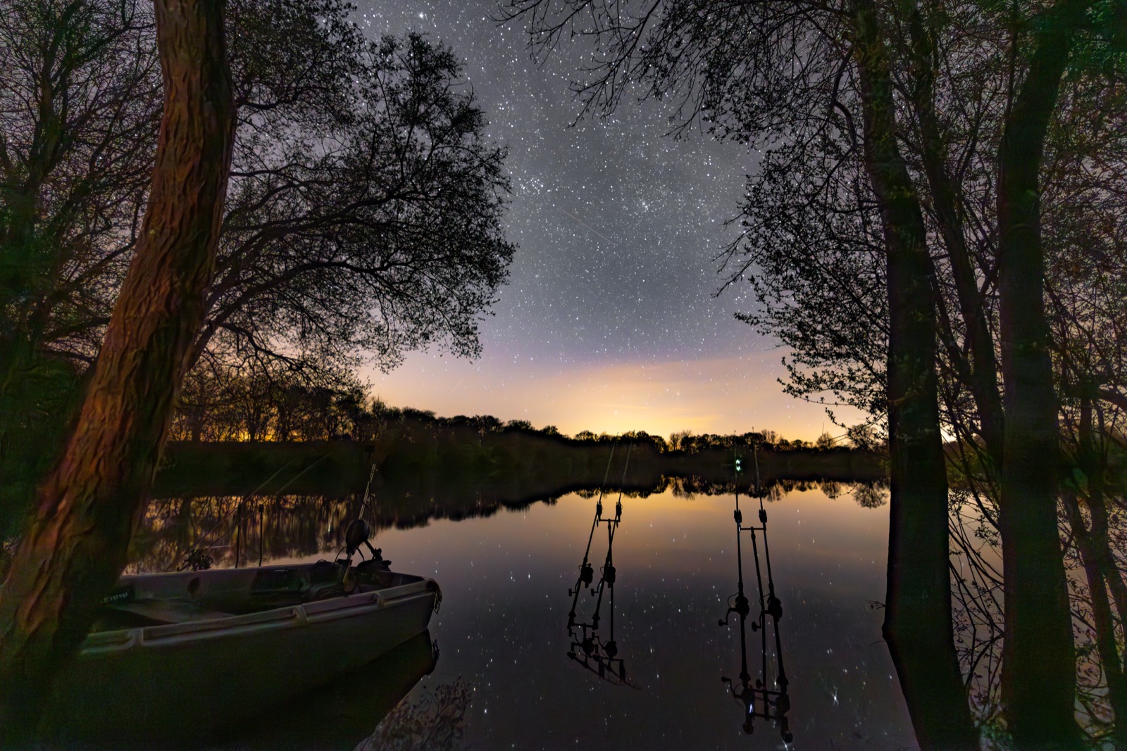 Rods out under a starry night sky over a still lake